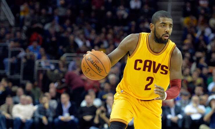 A basketball player in a yellow Cavaliers jersey, dribbling with the precision of a winning brand, commands the court during an intense game. Consensus