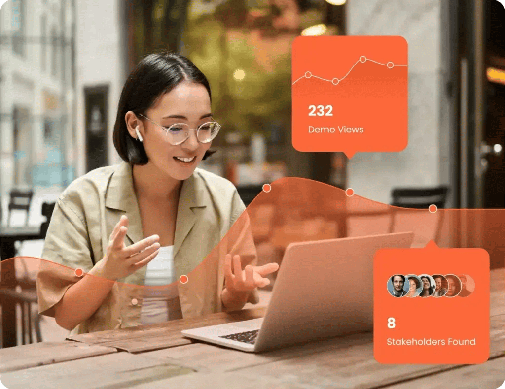 A woman wearing glasses and earbuds sits at an outdoor table, speaking while looking at her laptop. Overlay graphics display "232 Demo Views" and "8 Stakeholders Found." It appears she's participating in a session from Consensus Academy.