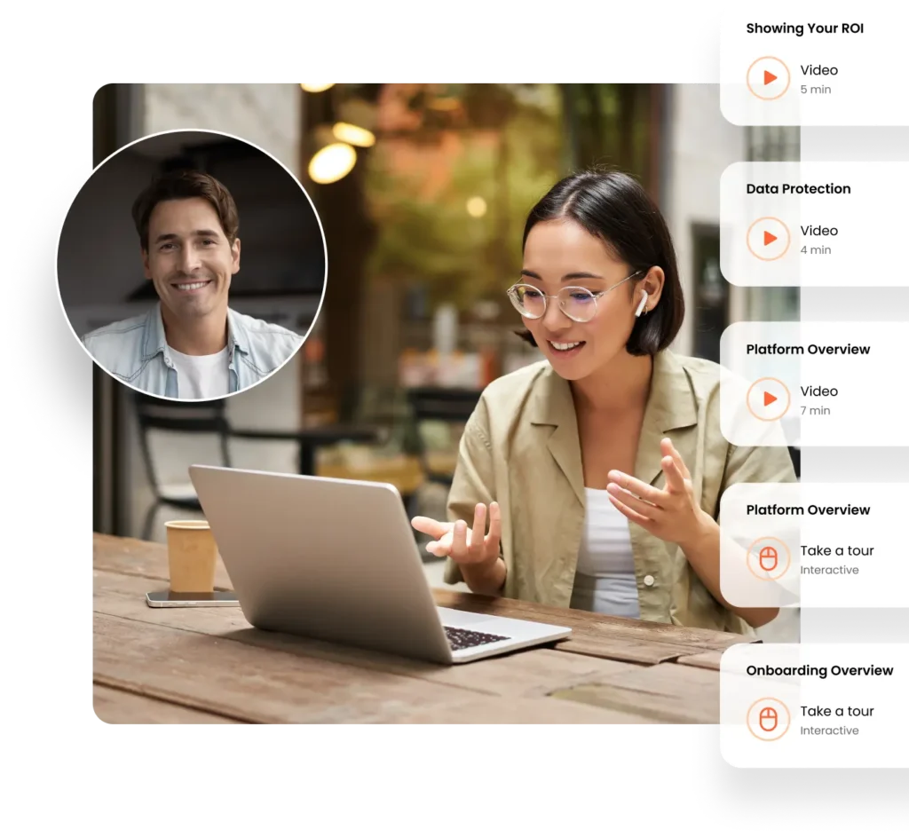 A woman wearing glasses is sitting outdoors at a wooden table using a laptop while discussing sales strategies. Next to her is a sidebar listing video options for ROI, Data Protection, Platform Overview, and Onboarding Overview.