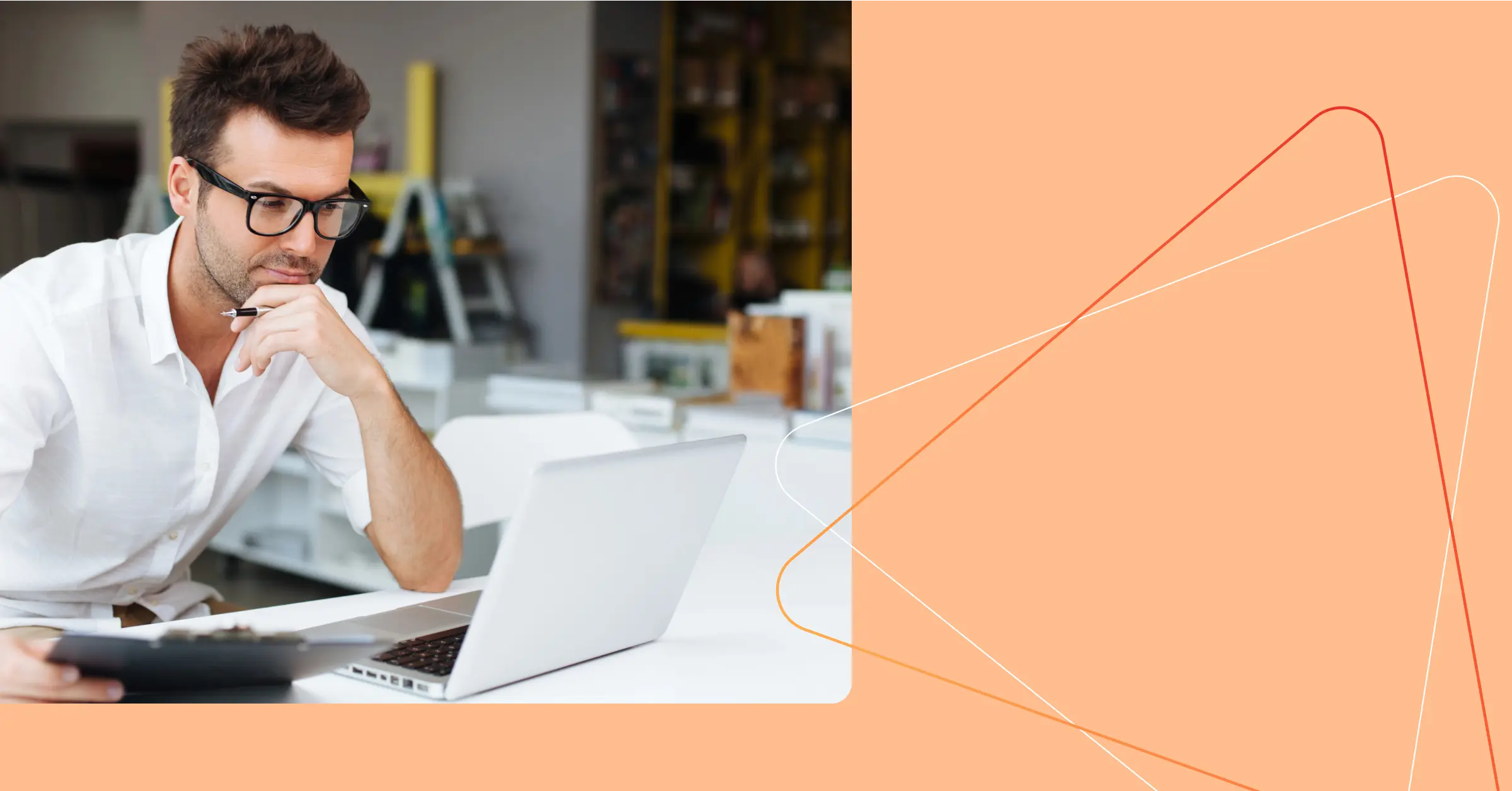 Man in glasses sitting at a desk, looking at a laptop screen and holding a clipboard, with an orange graphic background on the right. Consensus