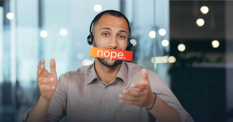 A man wearing a headset with a red "nope." label covering his mouth, gesturing with his hands during a sales demo in an office setting.