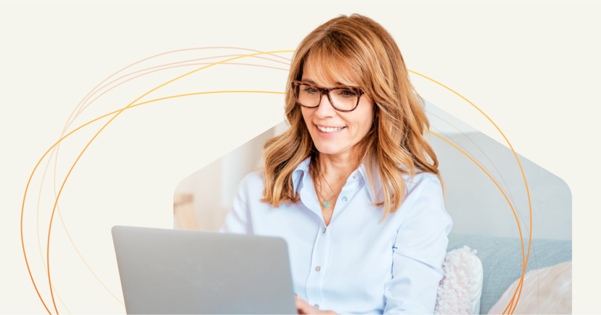 A woman wearing glasses is using a laptop to think and enhance her emotional ROI.