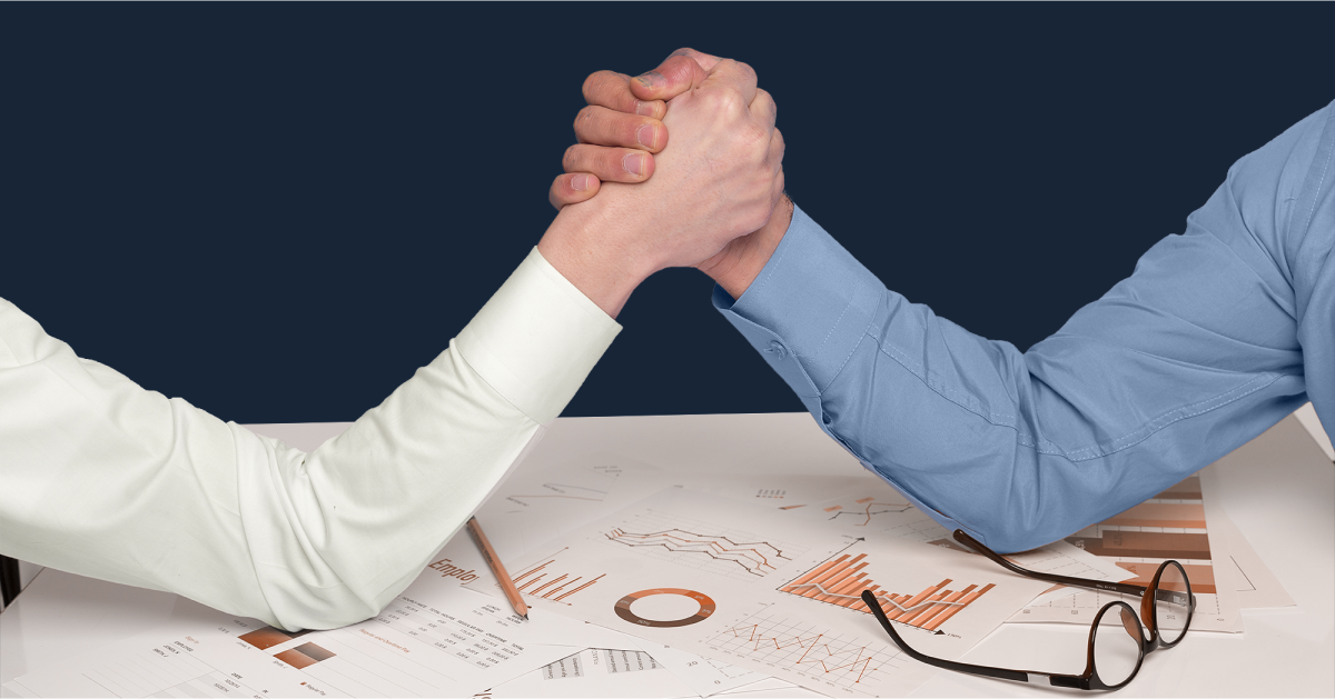 Two leaders shaking hands at a desk.