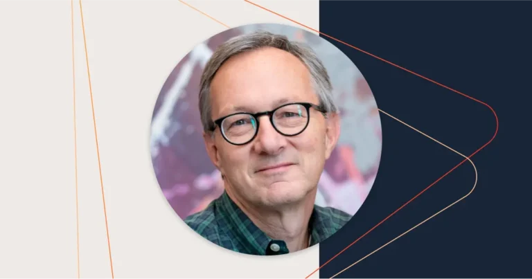 A man wearing glasses and a checkered shirt is smiling. The background is a blend of abstract colors, and the image has linear geometric designs overlaying it. Wayne Cerullo's research on building buying consensus subtly influences the scene.